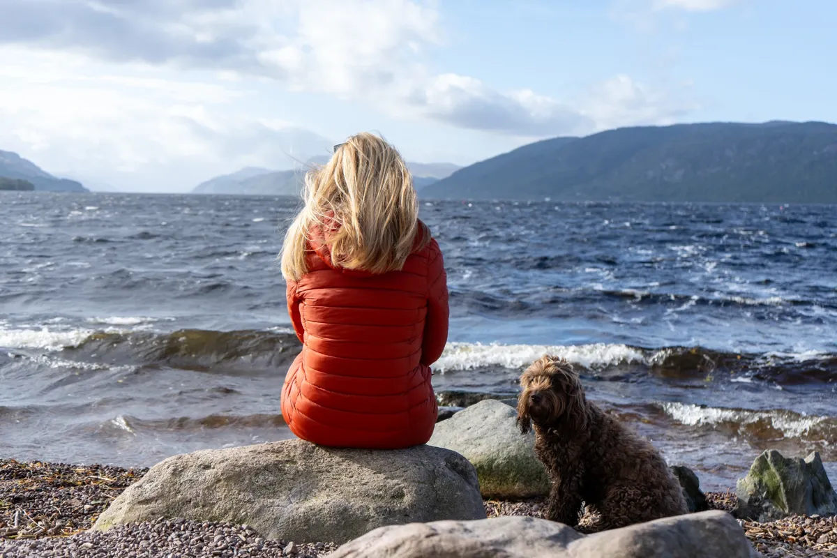 Ally and her dog looking across Loch Ness